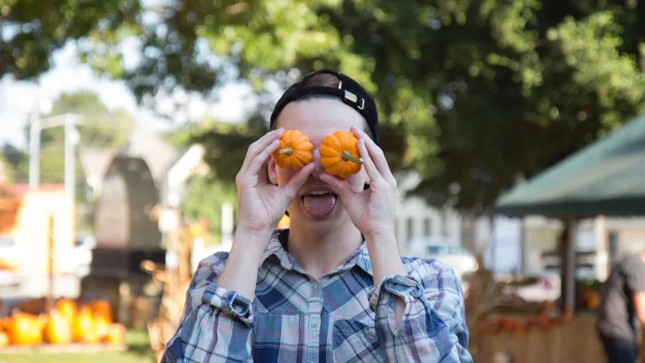 Joking with small pumpkins for eyes